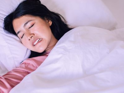 Asian,Woman,Sleeping,And,Grinding,Teeth,In,Bedroom,female,Tiredness,And TMJ pain or facial discomfort